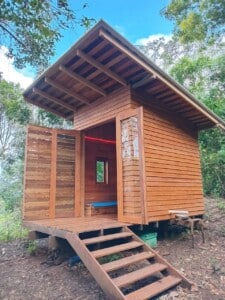 The wooden bee house with its entrance steps